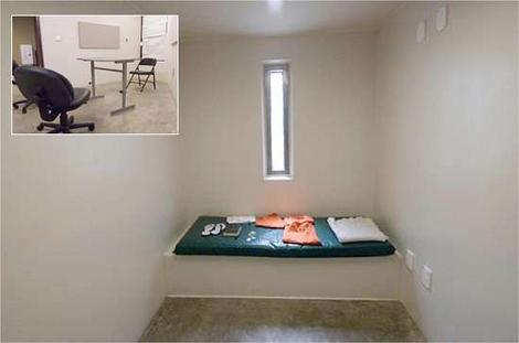 This is said to be David Hicks's cell, in Camp Six. The windows looks down on central common rooms, which are left vacant, as a change in policy, to turn the facility in a "supermax" facility, made common rooms redundant. The inset picture is of a "reading room". Captives are, occasionally taken to these "reading rooms", during their one-hour per day they are taken from their cell. However, they remain in isolation. Only one captive at a time is allowed in each reading room or exercise yard.