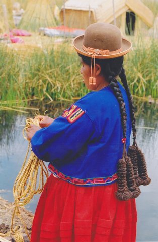 File:Uros Indian woman on a uros cane island in the titicaca lake in Peru.jpg