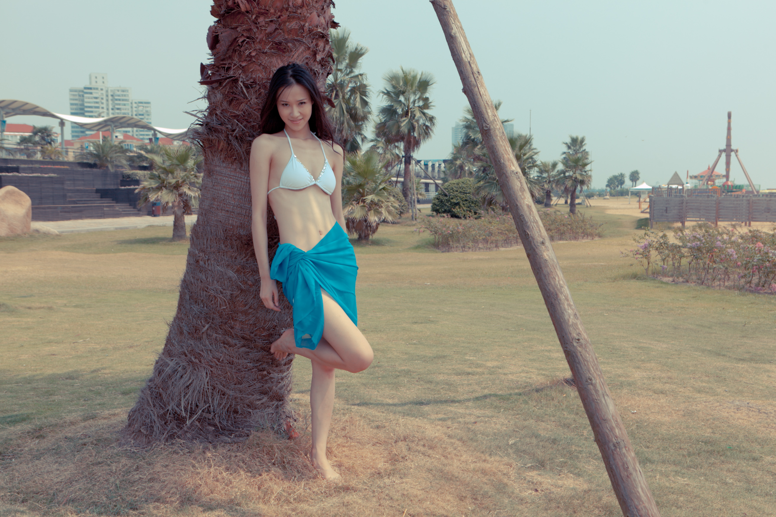 FileAsian model leaning against a palm tree (6775969659) photo