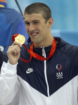 Michael Phelps holding his gold medal from the 4 x 100 relay Michael Phelps medal 2008 Olympics.jpg