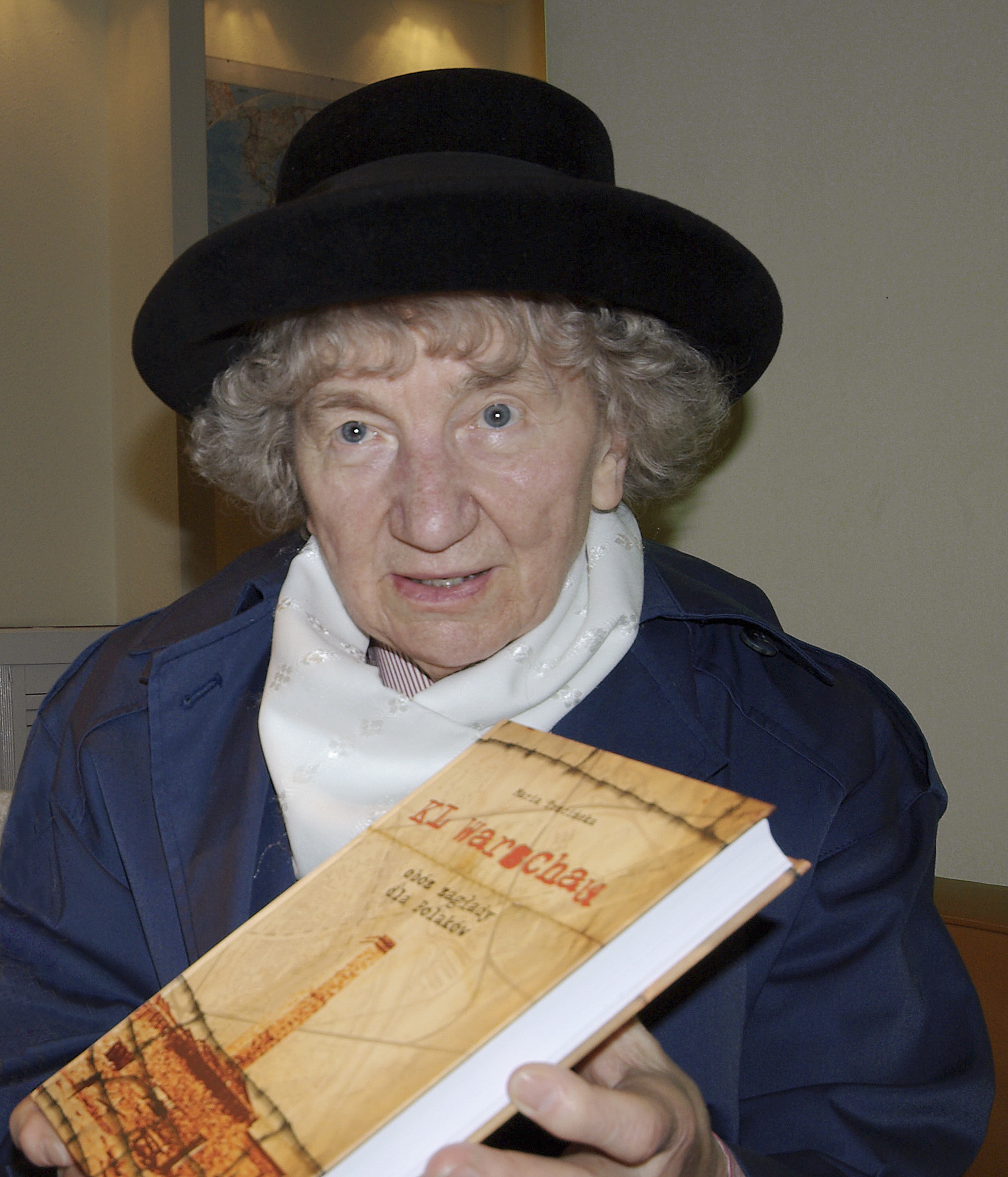 Maria Trzcińska holding a copy of her publication ''KL Warschau – obóz zagłady dla Polaków'', 2008