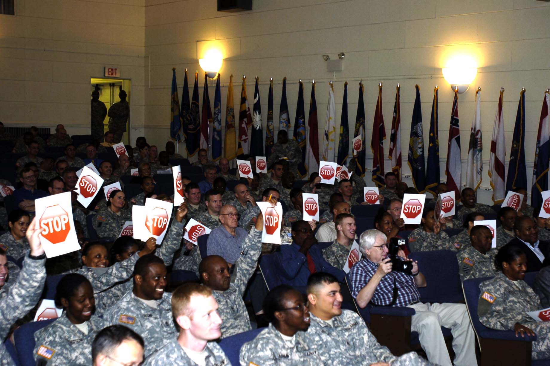 Army 51113 Despite laughs, Sex Signals shows sexual assault is no joke.jpg English: Audience members hold up "stop signs" to indicate things are getting