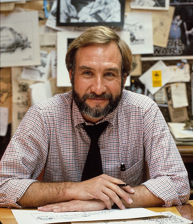 Auth, working in front of sketches of his cartoons, 1980