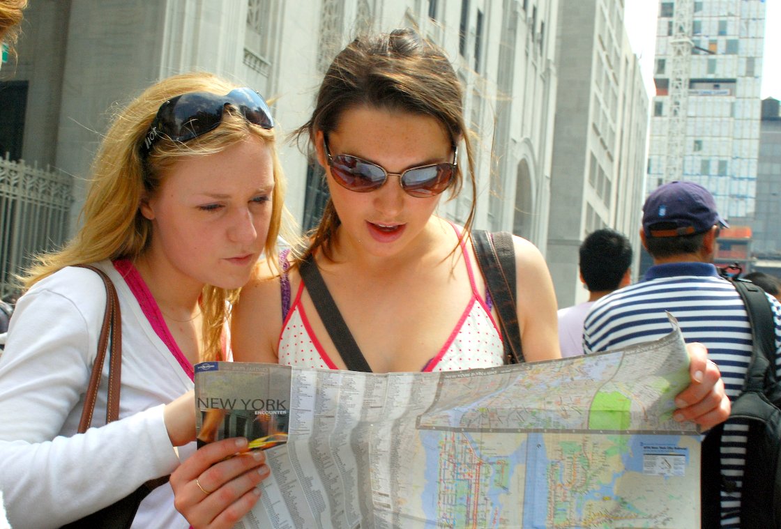 travelers reading a paper map