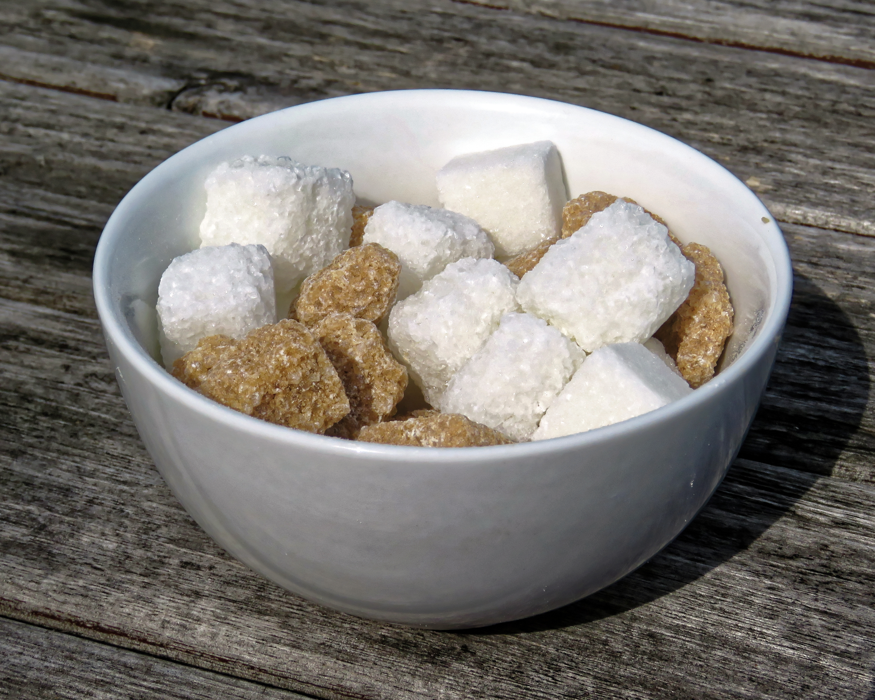 Cubes of sugar in a bowl of cereal.