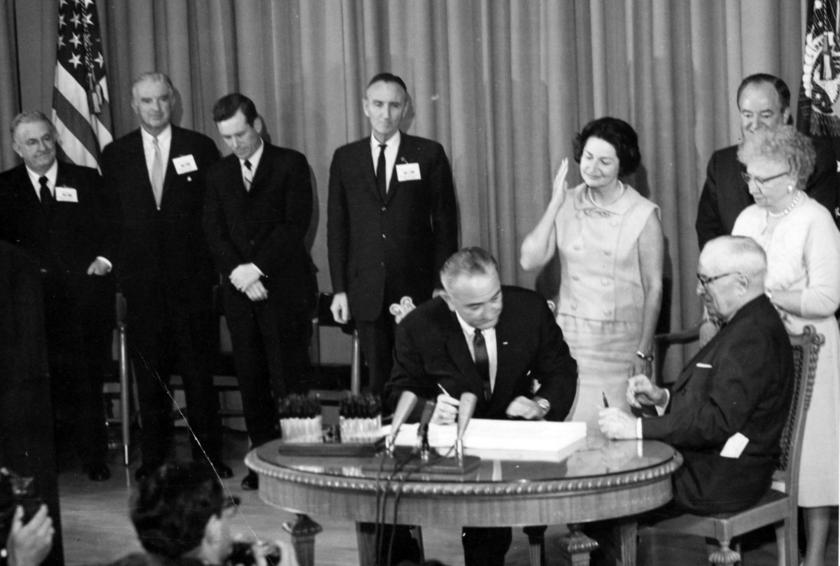 President Lyndon B. Johnson signs Medicare Bill at the Harry S. Truman Library, 1965.jpg