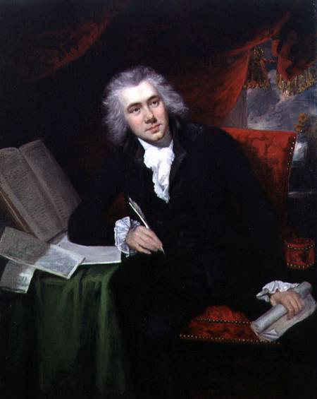 Portrait of William Wilberforce sitting with quill pen in hand at a desk covered in books and papers.