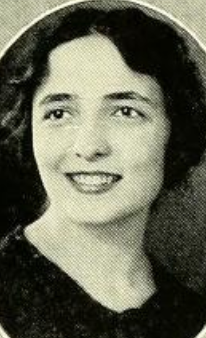A smiling young white woman with dark hair and eyes, in an oval frame