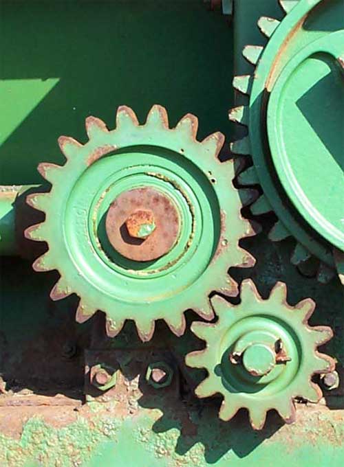 2 gears and an idler gear on a piece of farm equipment, with a ratio of 42/13 = 3.23:1