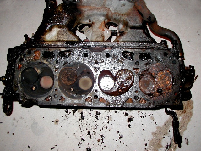OHV head for a GMC van (view of underside, with valves and exhaust manifold also visible)