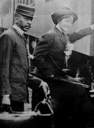 A Pullman porter assisting a passenger with her luggage