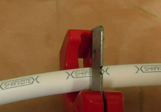 File:Shower project cutting half inch PEX pipe with tube cutter.jpg