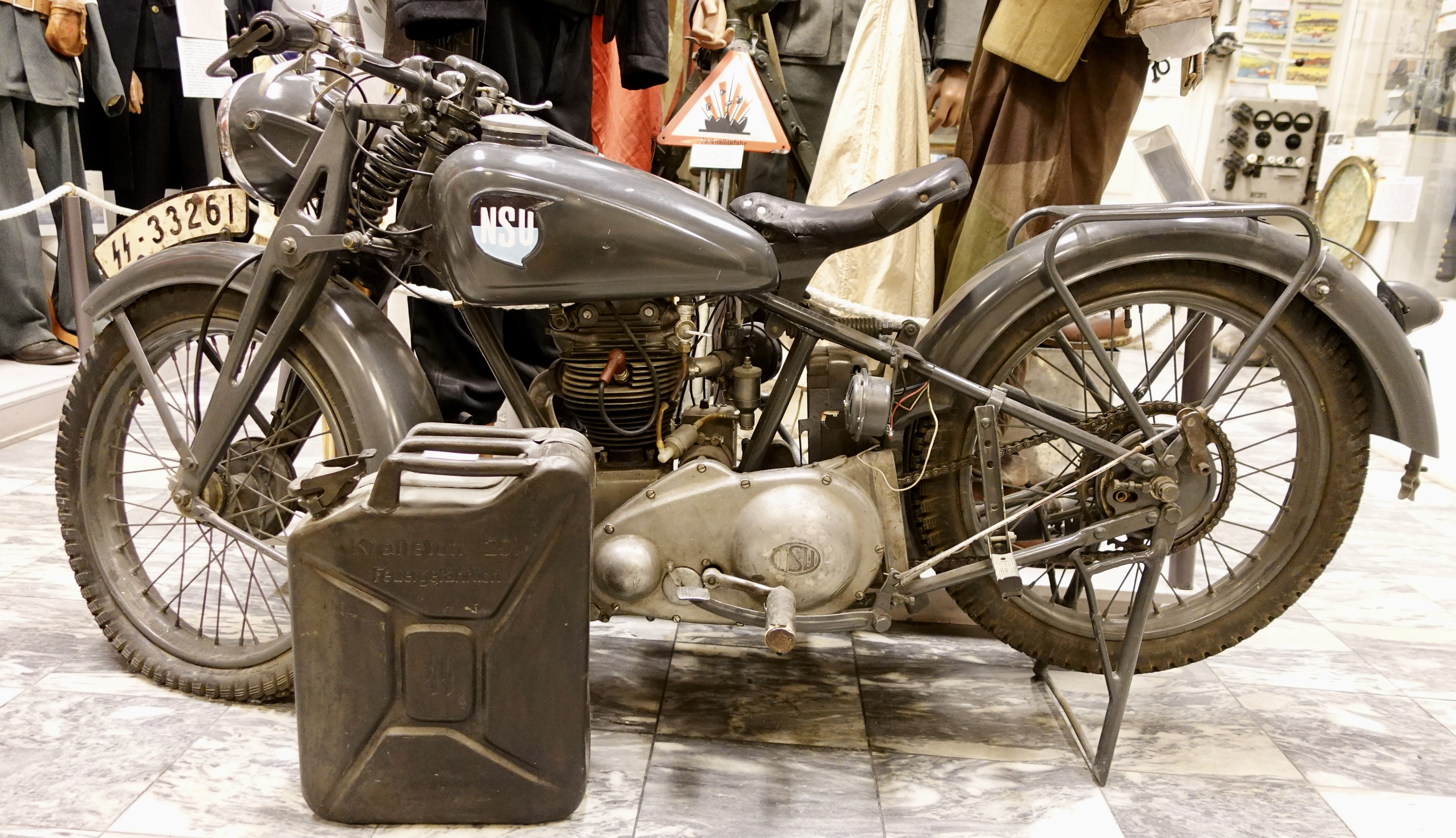 https://upload.wikimedia.org/wikipedia/commons/4/46/NSU_Motorfahrrad_Motorrad_German_military_motorcycle_license_plate_SS_333261_jerrycan_container_20l_Kraftstoff_feuergefaehrlich_Zerknallgefahr_explosion_warning_sign_Lofoten_Krigsminnemuseum_WWII_Museum_Norway_2020_DSC01650.jpg