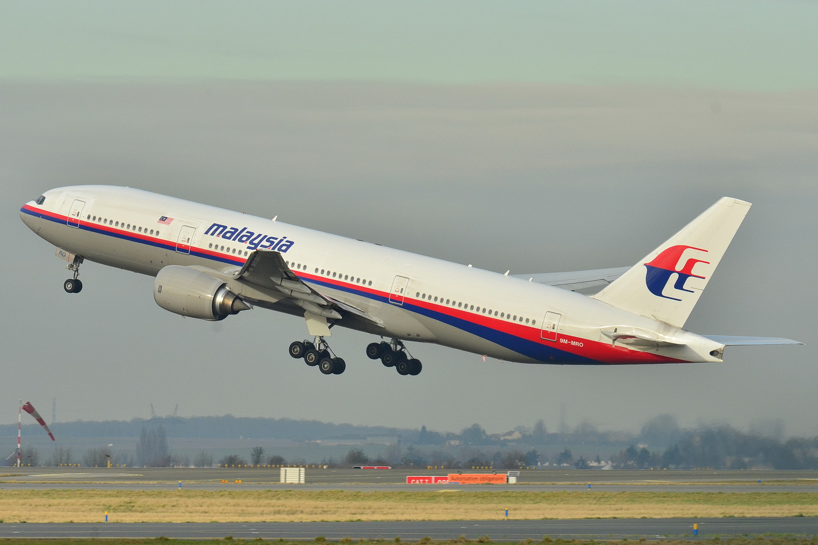 A Boeing 777 in Malaysia Airlines livery just after lifting off the runway