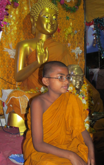 Young Indian Buddhist monk in Indian monastery