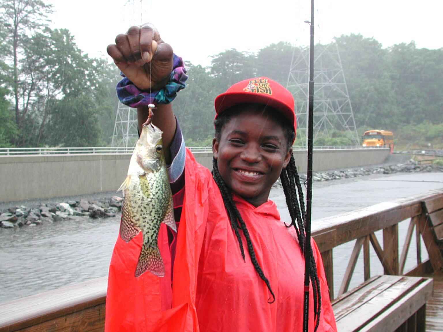 File:Young African American teenage girl smile and enjoy fishing on a rainy  day.jpg - Wikimedia Commons
