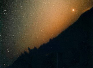 The zodiacal light, parts of which are reflected by interplanetary dust, which in turn originates in part from collisions of asteroids