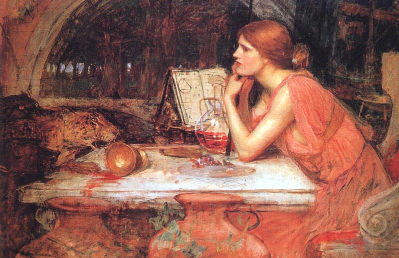 Woman in pinkish red dress seated at table