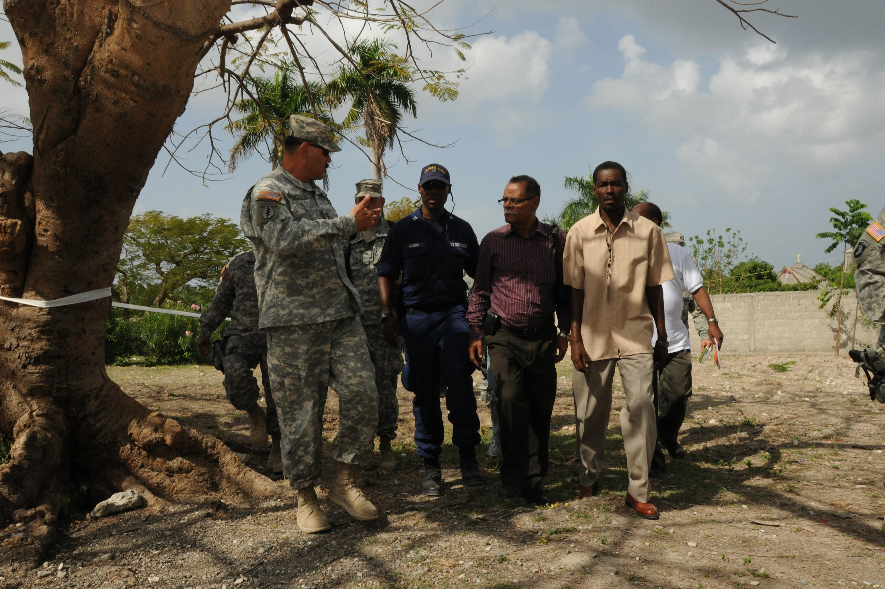 Maj. Gen. Simeon G. Trombitas, commanding general, Joint Task Force-Haiti, left, talks with Dr. Alex Larsen, Haiti's minister of health, second from right, during a visit to a U.S. Army Medical Readiness Training Exercise in Coteaux, Haiti, April 29, 2010. The exercise is allowing U.S. iand Haitian medical care providers to offer free level-one medical care to Haitians in the community in support of Operation Unified Response. Taken on 29 April 2010 by Kaye Richey. Digitally posted at https://www.dvidshub.net/image/632133