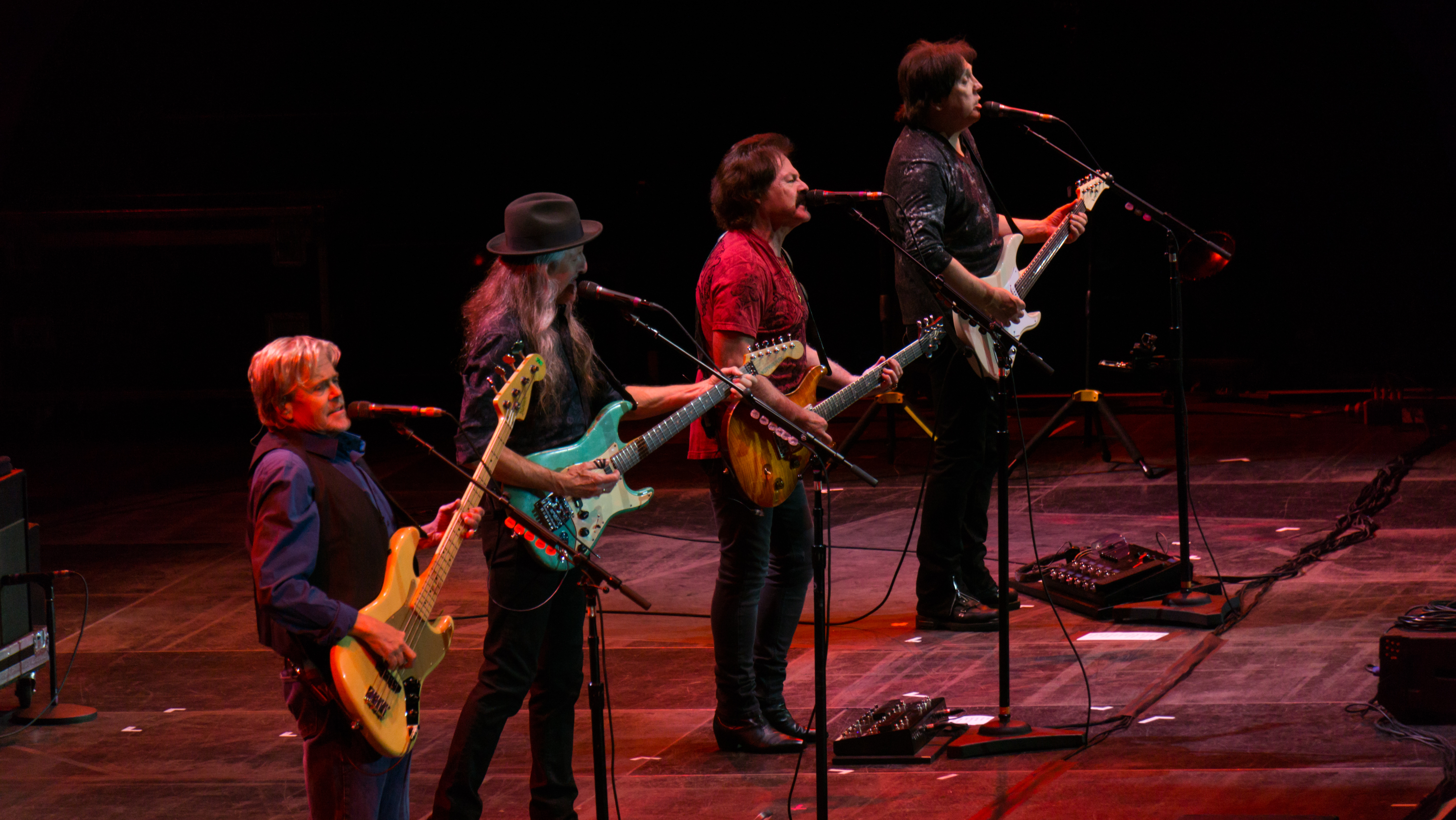 The Doobie Brothers performing in 2017. From left: touring member [[John Cowan]], [[Patrick Simmons]], [[Tom Johnston (musician)|Tom Johnston]], and [[John McFee]].