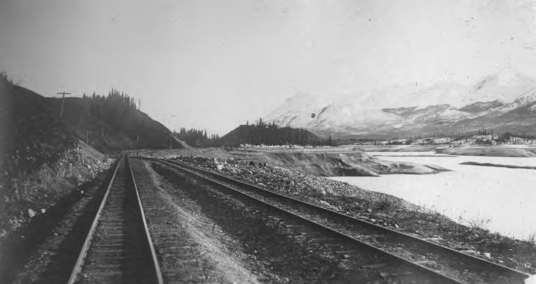 File:White Pass and Yukon Railroad tracks and train between hillside and shore of Bennett Lake, May 1906 (AL+CA 7042).jpg