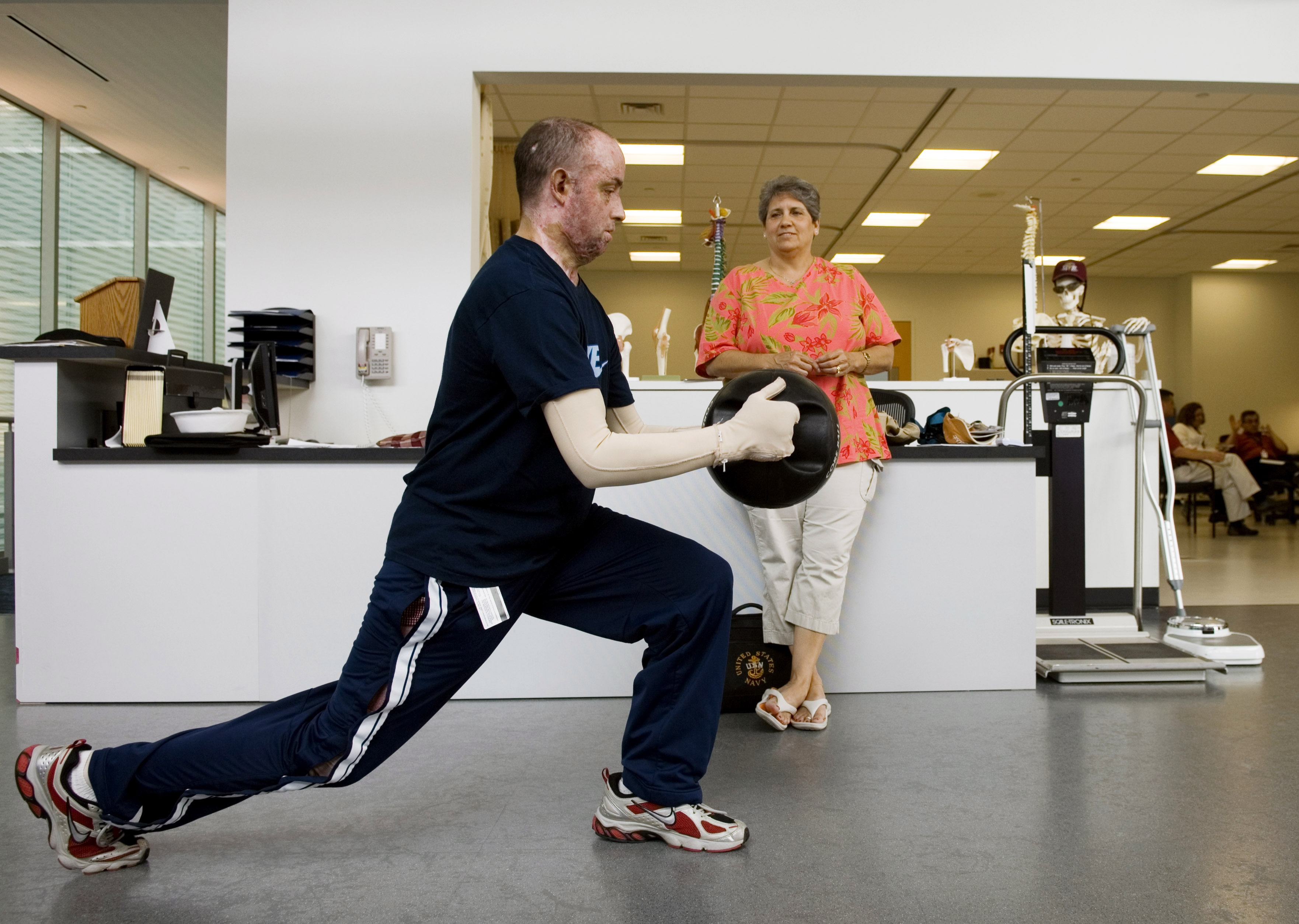 rehab exercises while his mother watches in the Center for the Intrepid abo...