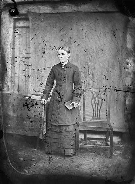 File:A woman standing holding a book NLW3364749.jpg