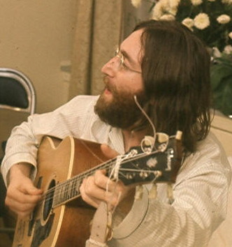 Lennon playing "Give Peace a Chance" in Montreal, 1969