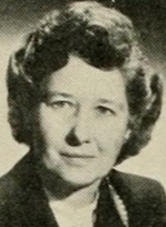 A middle-aged white woman with hair in a set style