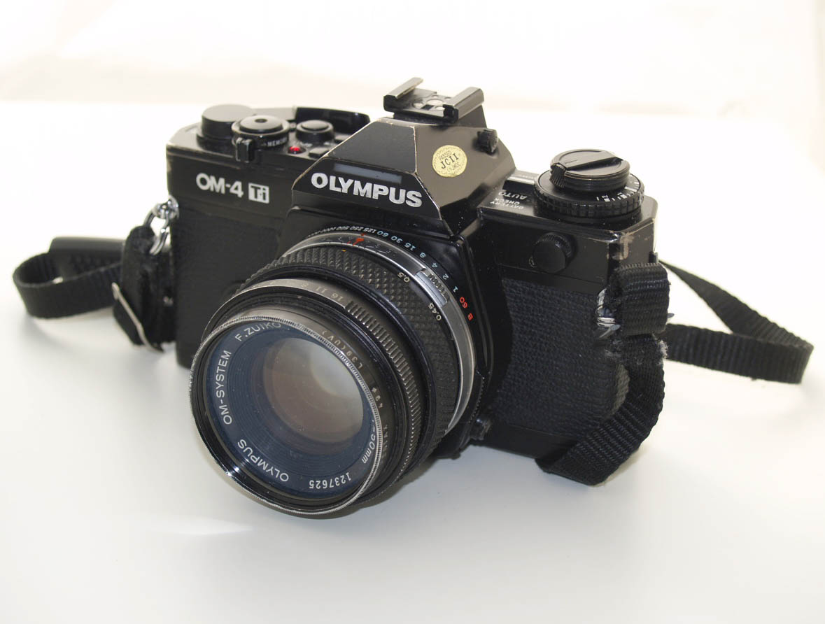 File:Olympus OM-4Ti worn black body with Zuiko 1.8-50mm lens and  neckstrap.jpg - Wikimedia Commons