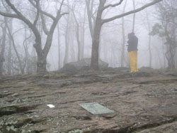 A hiker signs the register at the southern terminus on Springer Mountain