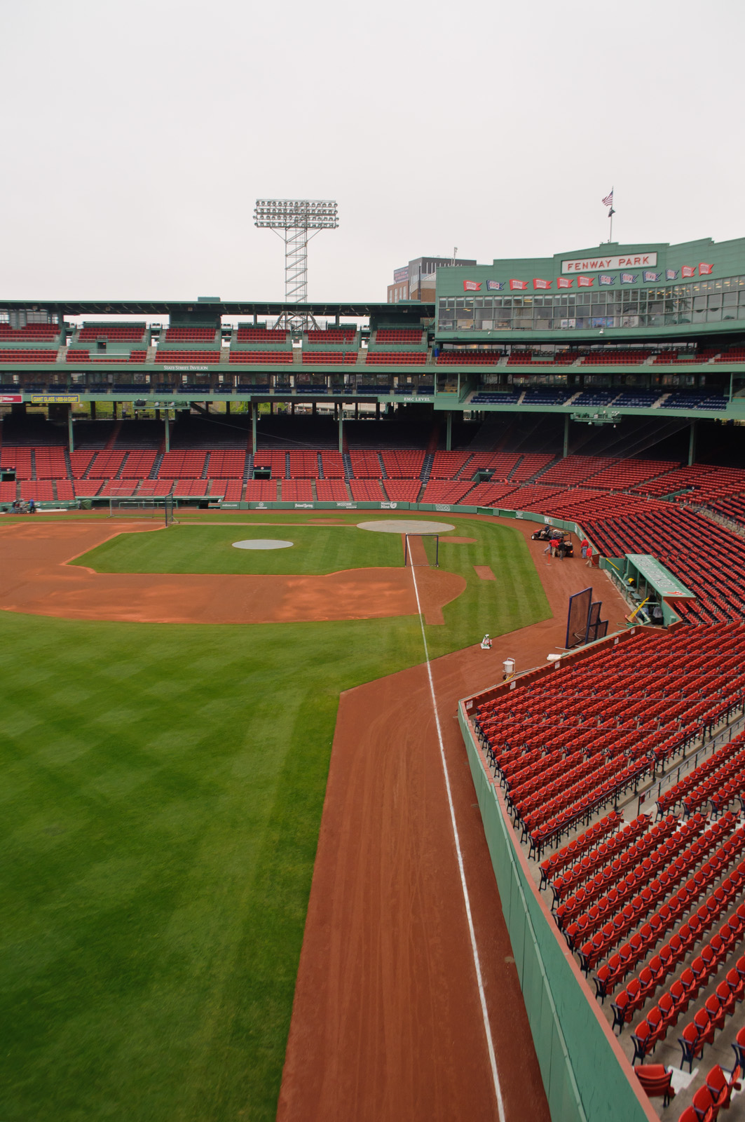 Boston, Massachusetts, USA. April 19, 2012. Dozens of Red Sox fans sit in  the Green Monster Seats at Fenway Park on its 100th Anniversary Open House  whilst hundreds walk on the warning