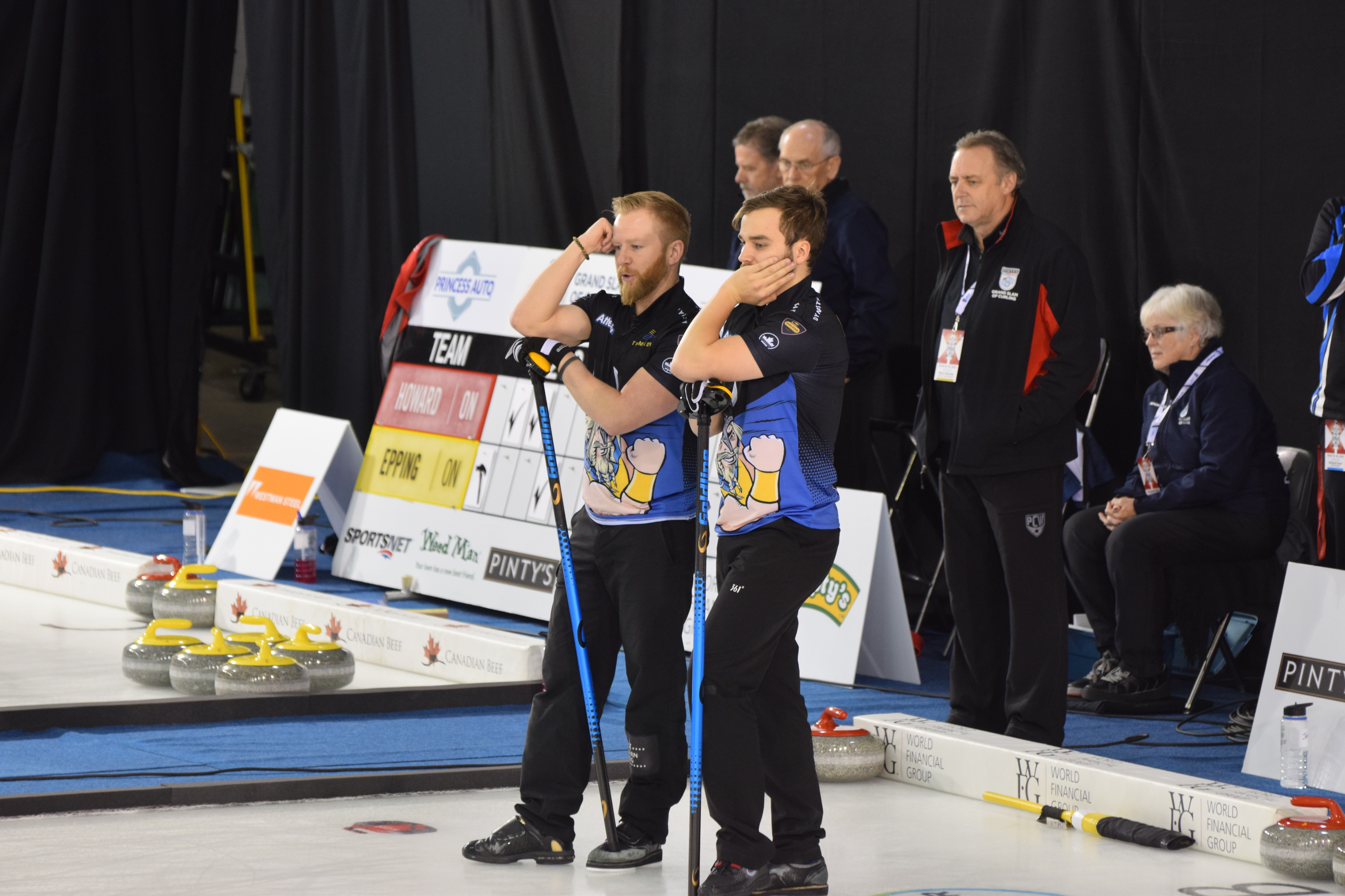 [[Niklas Edin]] and Oskar Eriksson watch their opponent throw his rock at the 2018 Elite 10 Grand Slam curling event in Winnipeg, Manitoba.