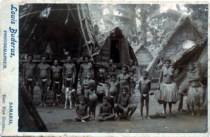 File:Group of native women and children outside village houses, British New Guinea.jpg