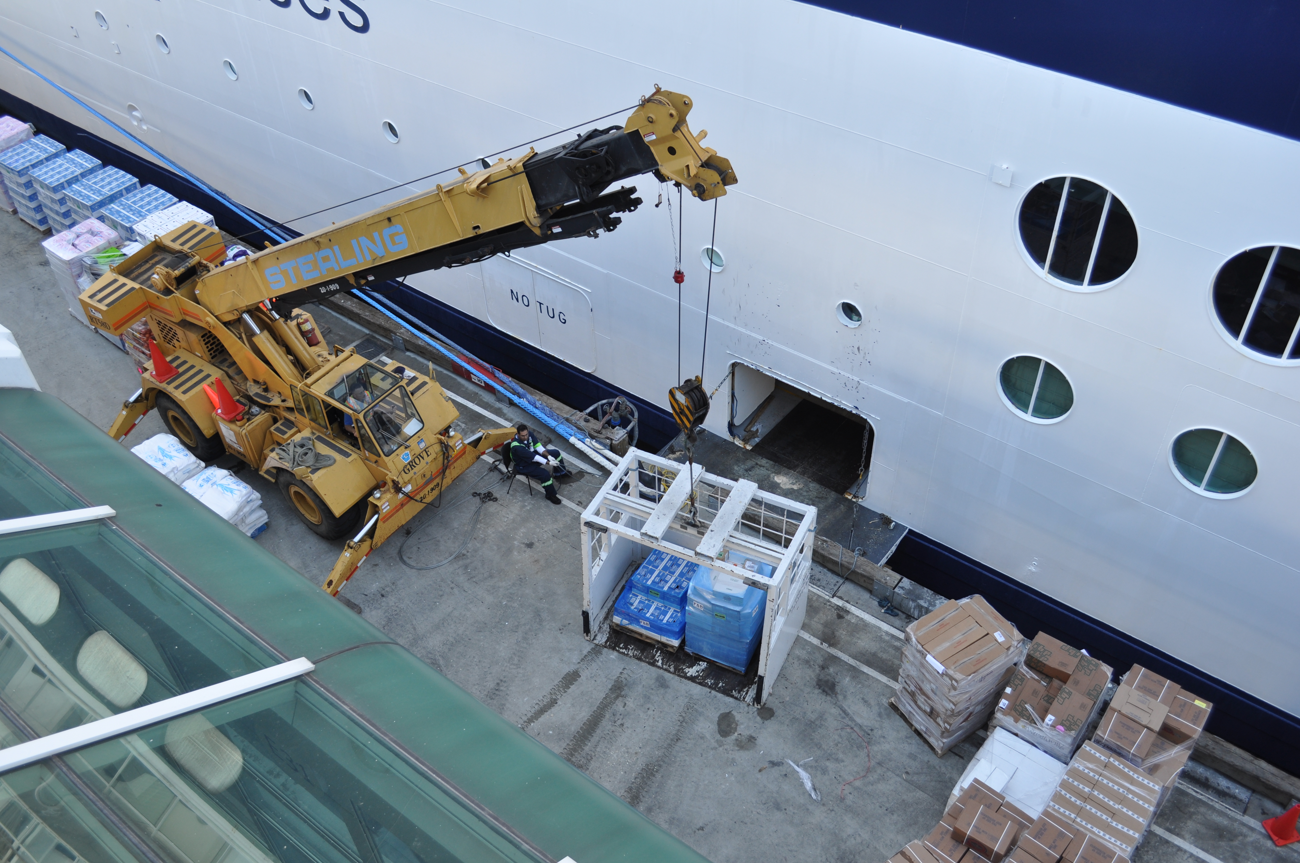 Crane loading cargo onto a cruise ship.