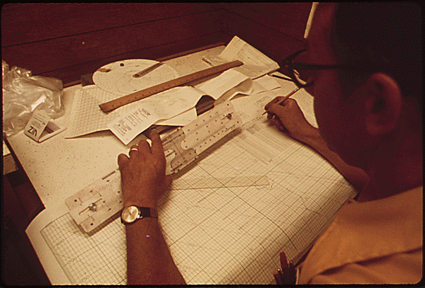 File:Calculating by slide rule.png