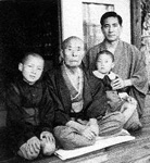 A portrait of the men of the Koizumi family in the 1940s or early 1950s. Junichiro is at left and Matajiro is in center; Jun'ya is holding his son Masaya at right. Koizumi family.jpg