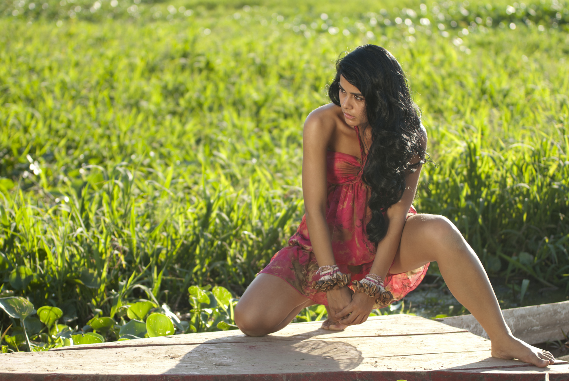 Barefoot kneeling women.