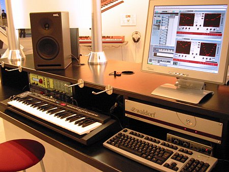 Musik Messe 2003: PC running ROT Analog Filter Step Sequencer. AFB-16 (2003) below. rackAttack (2002, here in the later color combination of blue/yellow) and microQ (2000, classic blue) below the speaker on the left. Q+ (2002) in the background Waldorf-at-messe-frankfurt-2003.jpg