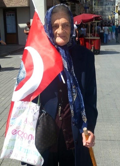 File:Old lady with a flag on Taksim Square.jpg