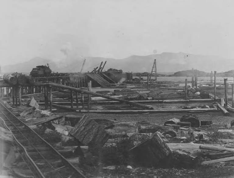 File:Log train of the Bloedel, Stewart and Welch Company, dumping logs from pier at Myrtle Point near Powell River, 70 miles (AL+CA 7806).jpg