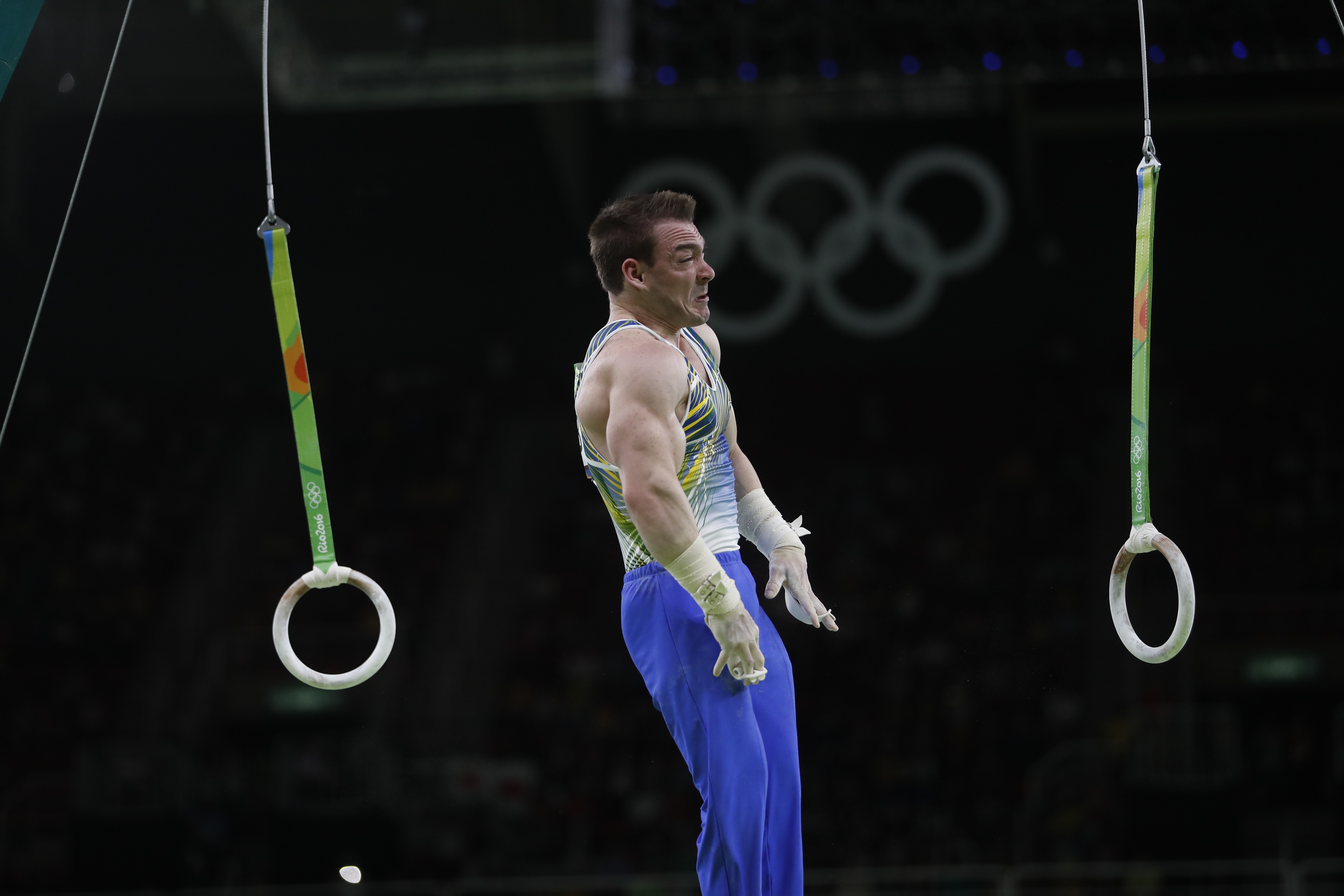 Boy doing gymnastics on two rings hanging ropes Vector Image