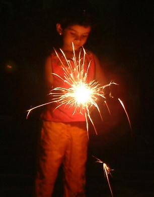 A child playing with fireworks on Vishu