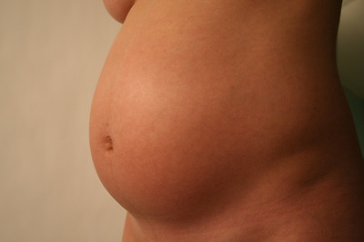 Side view of a pregnant tummy.