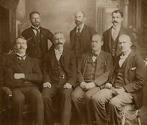 Seven of the eight officers of the American Railway Union jailed in connection with the 1894 Pullman strike—standing from left to right: George W. Howard, Martin J. Elliott, Sylvester Keliher; seated: William E. Burns, James Hogan, Roy M. Goodwin Eugene V. Debs; and not shown: L. W. Rogers