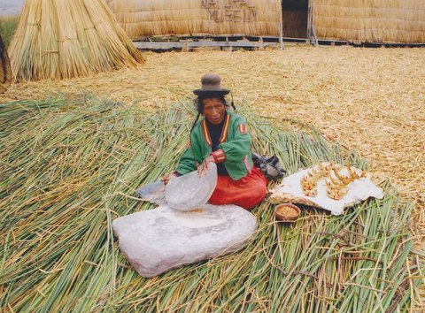 File:Uros Indian woman who works with a grind and small Wicker toy boats sells to tourists.jpg