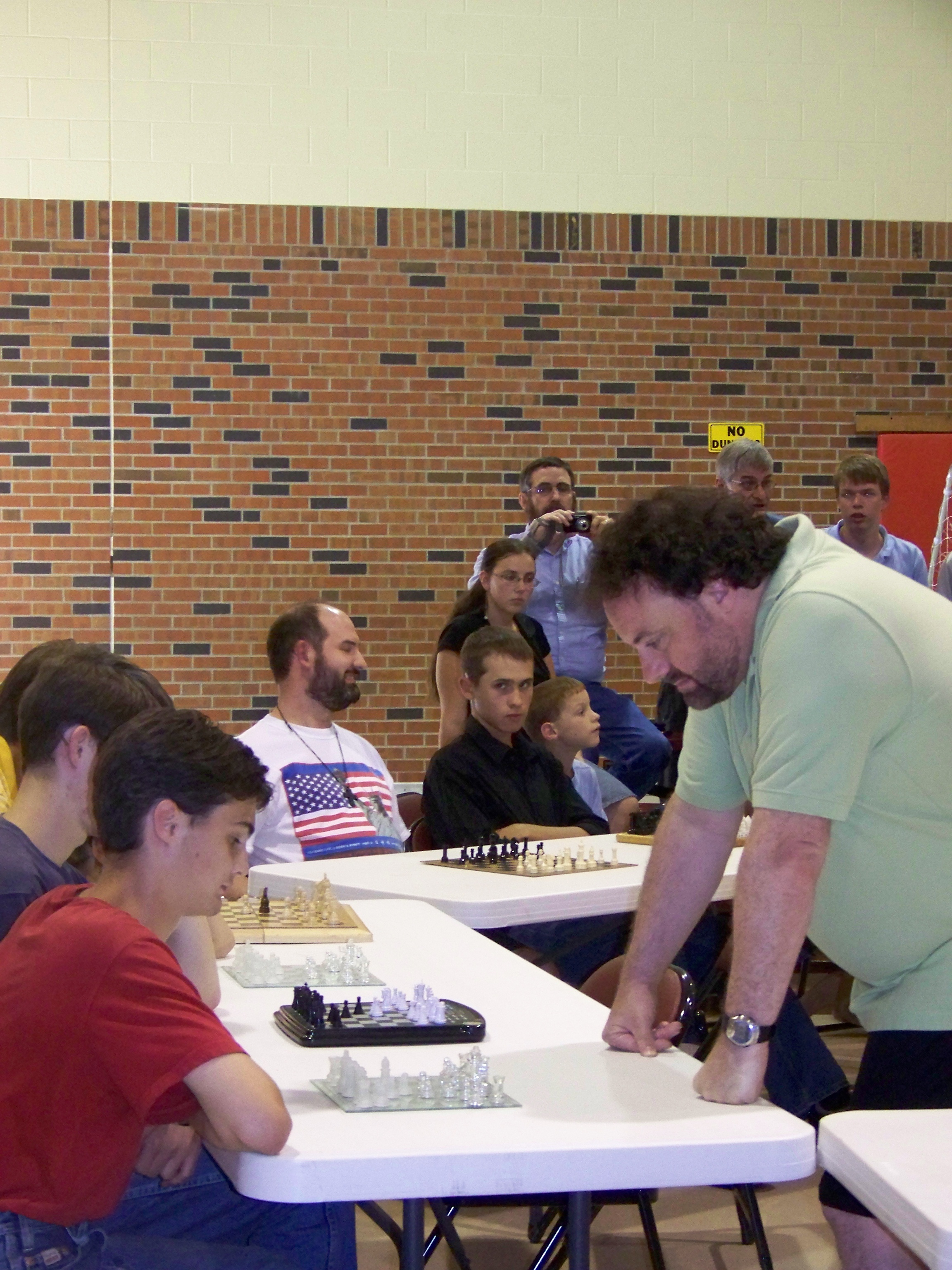 Sarfati playing chess against multiple players at a creation conference, 2011.