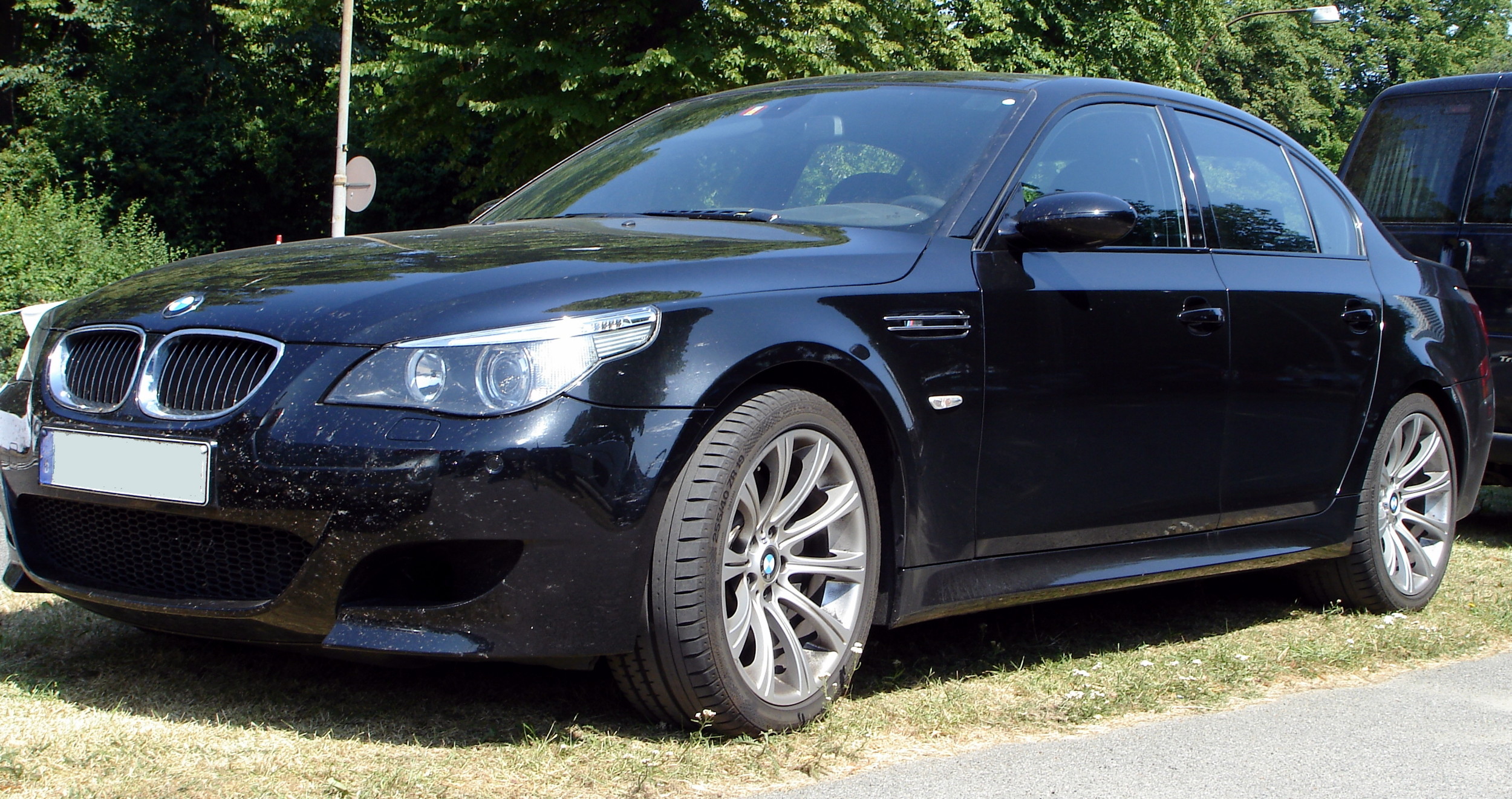 BMW M5, model year 2005-, black, driving, diagonal from the front, frontal  view, test track Stock Photo - Alamy