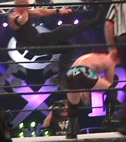 Buchanan (left) delivering a scissors kick to Crash Holly at King of the Ring in June 2000.