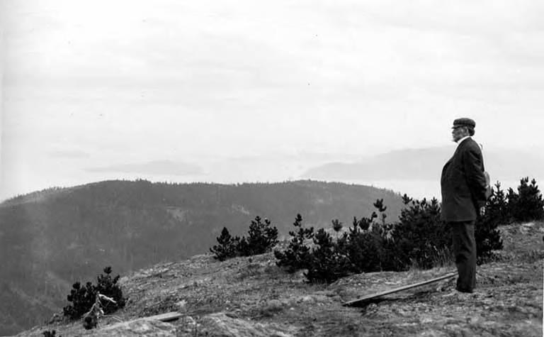 File:Man standing on the summit of Mt Constitution, Orcas Island, ca 1910s (WASTATE 2662).jpeg